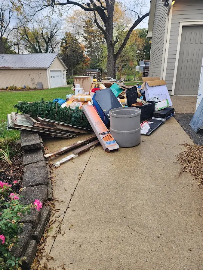 Dumpster being loaded with debris for Estate Cleanout Dumpster Rental in Port Townsend